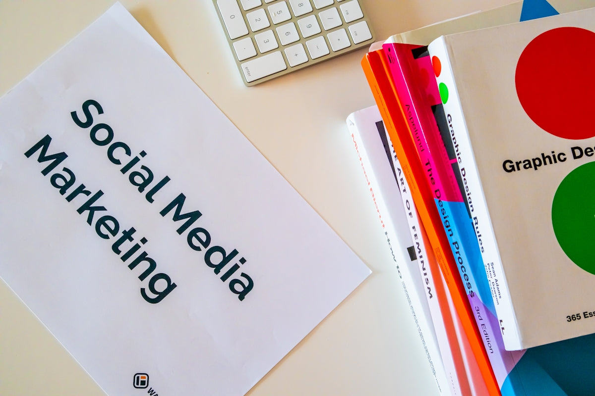 a sign that says social media marketing next to a keyboard